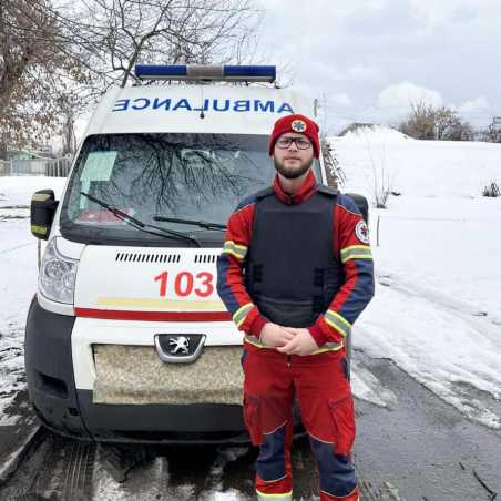 Medical student in front of ambulance