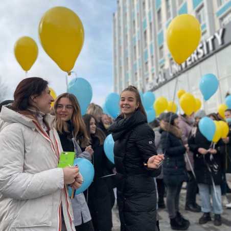 Happy students with balloons